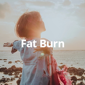 a woman holding out her arms over an ocean sunset with the words fat burn
